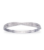 A twist on classic style, from Swarovski. Add some shimmer to your wrist with this Edith bangle bracelet featuring sparkly crystal accents. Crafted in rhodium-plated mixed metal. Approximate diameter: 3-1/4 inches.