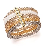 Bring warmth and energy to your ensemble with gold tones and a hint of sparkle. Ali Khan bracelet features five scintillating rows of champagne and neutral-colored glass beads with a row of rhinestone accents. Crafted in gold tone mixed metal. Bracelet stretches to fit wrist. Approximate diameter: 2 inches.