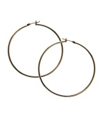 Snap up effortless style in simple hoops. GUESS earrings feature a polished, large hoop design in gold tone mixed metal. Approximate diameter: 1-1/2 inches.