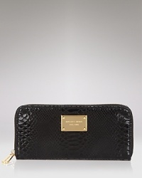 Lend your look contemporary polish with this python-embossed patent leather continental wallet from MICHAEL Michael Kors.