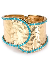 Nail this season's eclectic jewelry trend with this gleaming cuff from Cara. Crafted from metal plate with turquoise colored stones, this bohemian piece will work just as well for day as for night.