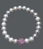 A traditional design receives a sparkling touch. Cultured freshwater pearls (8-9 mm) in shimmery grey hues adorn this chic stretch bracelet, while a purple crystal fireball adds extra glamour. Approximate diameter: 3-1/2 inches.