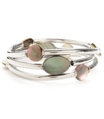 Cool, eclectic and contemporary. Kenneth Cole New York's shimmery bangle set features three, unique styles with round and oval-cut shell accents. Set in silver tone mixed metal. Bracelets stretch to fit wrist. Approximate drop: 2-1/2 inches.