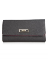 Stay organized anywhere you go with this travel-ready wallet from DKNY that's the right reserve for all your riches. Luxe leather is accented with custom hardware, while the interior is outfitted with plenty of pockets and compartments.