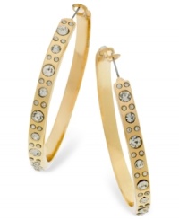 Add a spark to your look with these shimmering hoops from GUESS. A golden silhouette is embellished with glass accents. Crafted in gold tone mixed metal. Approximate diameter: 2-1/4 inches.