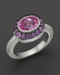 An sterling silver ring with faceted oval pink corundum stone and amethyst pave frame. By Judith Ripka.