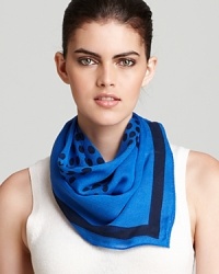 A lightweight scarf with a large yet subtle polka dot Tory Burch logo print