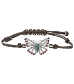 Fashionably fluttering. Fossil's free-spirited butterfly bracelet features purple and clear-colored crystals, reconstituted turquoise, and a chocolate leather adjustable wrist wrap. Set in silver tone mixed metal. Approximate diameter: 2-1/2 inches.