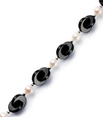 Striking contrast. Overlapping onyx discs (12 mm) combine with cultured freshwater pearls (6-1/2-7 mm) for a bold and elegant look. Set in sterling silver. Approximate length: 7-1/2 inches.