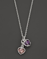 A twin heart necklace in pink and raspberry crystal framed in sterling silver. Designed by Judith Ripka.