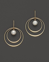 Beautiful textures in 14 Kt. yellow gold. A double hoop earring with fresh water pearl center.