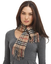 Luxuriously soft cashmere scarf in an all over check pattern is finished with fringe trim.