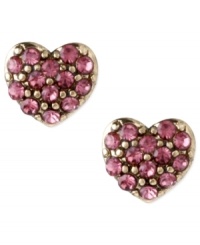 Turn on your heart light. Betsey Johnson's pretty-in-pink heart stud earrings are adorned with round-cut crystals. Crafted in antiqued gold tone mixed metal. Approximate diameter: 1/3 inch.