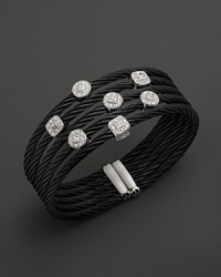 Diamonds set in white gold on a stainless steel and black PVD bangle. By Charriol.