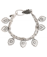 Lucky Brand turns over a stylish new leaf with this charm bracelet. It's crafted from silver-tone mixed metal with plastic accents adding to the appeal. Approximate length: 7-5/8 inches.