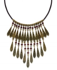 Dress your neckline with classic elegance with this bib necklace from Lauren Ralph Lauren. Teardrop beads in golden tones are paired with round accents. Strung from a brown fabric cord. Crafted from gold tone mixed metal. Approximate length: 16 inches + 2-inch extender. Approximate drop: 3-1/2 inches.