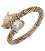 Fiercely fashionable. Carolee's elegant wrap bangle features a panther head with green glass eyes and an oval-cut clear glass accent. Set in textured antique gold tone mixed metal. Approximate diameter: 2-1/4 inches.