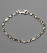 A stunning bracelet with crystal accents in an array of shapes, by Givenchy. Set in silvertone mixed metal. Approximate length: 7-1/4 inches.