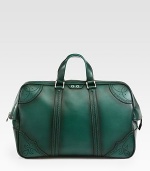 Green hand-stained leather duffel with perforated trim detail.Top zip closureLeather top handleInside pocket with a Gucci crest zipperFive metal feetVelvet Diamante liningLeather20.5W x 12.2H x 8DMade in Italy