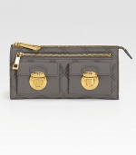 A bold take on color, this quilted leather design features chic goldtone accents.Zip closure One outside zip pocket One outside open pocket Two outside flap pockets with clasp closure Two center compartments Two inside bill slots Twelve credit card slots Cotton lining 8W X 4H X 1D Imported