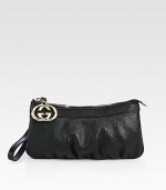 Wristlet with interlocking G charm in guccissima leather with leather trim and nickel hardware.Wristlet strap, 4 drop Zip-top closure Fully lined 8¾W X 4½H X ½D Made in Italy