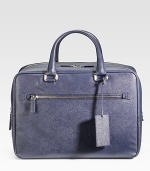 Sleek and sophisticated in textured saffiano leather with a double-zip closure. Leather handles Leather luggage tag Exterior zip pocket Interior zip pocket Fully lined 15¾W X 11H X 7D Made in Italy