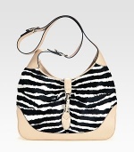 Lush zebra-striped haircalf pairs with rich leather in a roomy carryall.Adjustable and detachable shoulder strap, 8¾-19¾ dropPiston clasp closureOne inside zip pocketOne cell phone pocketOne PDA pocketLinen lining13W X 8¾H X 2¾DMade in Italy of imported fabric