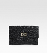 A cocktail essential covered in glittery fabric with a turnlock clasp and rich leather lining.Turnlock closure One inside open pocket Leather lining 9W X 6¼H X ½D Imported