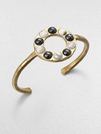 From the Cabochon Collection. A slender yet bold cuff is dotted with a circle of cabochon stones, some with a gunmetal finish, some with natural veining, all adding impact to this sophisticated design.Natural stone18k goldplatedDiameter, about 2.25Made in USA