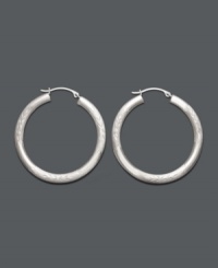 A style staple. Hoop earrings are a must-have for every wardrobe. This classic style comes in 14k white gold with a lever backing. Approximate diameter: 1-1/4 inches.