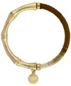 Jessica Simpson's hot, new design combines two of the latest trends in one. Ombre-hued brown wrapped cord decorates one half of this exotic bangle bracelet, while a bamboo branch and logo charm decorate the other. Set in gold-plated mixed metal. Bracelet stretches to fit wrist. Approximate length: 8 inches. Approximate diameter: 2-1/2 inches.