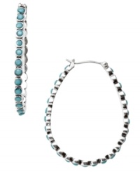 Turquoise teardrops. Fossil's mixed metal silver tone teardrop-shaped hoop earrings feature reconstituted semi-precious turquoise stones. Approximate drop: 1-1/2 inches.