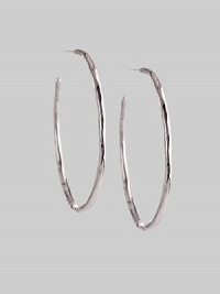 Delicate yet dramatic hoops of hammered sterling silver. Sterling silver Diameter, about 1¾ Post back Imported