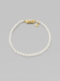 A strand of white cultured pearls with signature clasp closure.4mm white cultured pearls 18K yellow gold Length, about 7 Minuette clasp closure Imported 