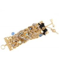 Start a conversation in this not-so-subtle style. Betsey Johnson's sparkling toggle bracelet combines detailed heart and flower charms combined with clear and blue crystal accents and a black grosgrain ribbon detail. Set in gold-plated mixed metal. Approximate length: 7-1/2 inches.