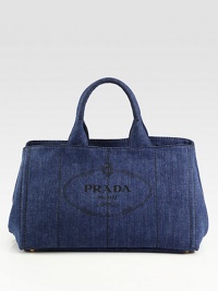 Chic denim style with heritage Prada logo print and stitch detail.Double top handles, 6 drop Open top Protective metal feet Two inside zip pockets Two inside open pockets 16W X 10H X 10D Made in Italy