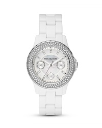 A crystal-encrusted bezel sets this chic white watch to sparkle. From MICHAEL Michael Kors.