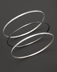 Two striking tones, three beautiful bangles from Gurhan, crafted in hammered white silver and dark silver.