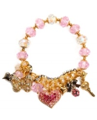 Won't you be my Valentine? Betsey Johnson's romantic style combines pink crystal hearts and beads with mixed metal heart and bow accents, pink crystal fireballs, clear crystal cup chains and gold tone mixed metal. Bracelet stretches to fit wrist. Approximate length: 7-1/2 inches.