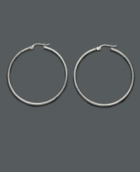 Add a playful touch to your look with fashionable hoops. These sterling silver hoop earrings feature a unique diamond-cut texture will never go out of style! Approximate diameter: 1-1/2 inches.