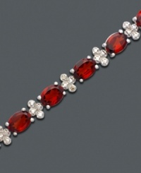 A tennis bracelet to die for. Bold oval-cut garnet (17 ct. t.w.) and diamond-accented links add instant drama. Bracelet crafted in sterling silver. Approximate length: 7 inches.