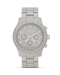 Surrender to sparkle with this Swarovski crystal-rimmed watch from MICHAEL Michael Kors, boasting an oversized case and pace-setting chronograph movement.