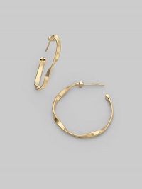 An updated version of a classic hoop, styled in 18k yellow gold with delicate ridges and intriguing twists. 18k yellow gold Diameter, about 1 Post back Made in Italy