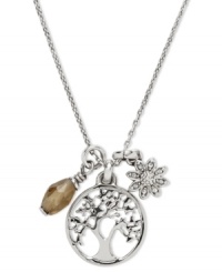 A nature-inspired necklace from Fossil. With a coin charm with cut-out tree detail, flower charm and faceted smoky quart cluster. Lobster claw closure. Crafted in shiny silver tone mixed metal. Approximate length: 16 inches + 1-inch extender. Approximate drop: 3/4 inch.