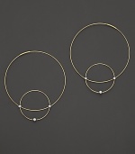 Like magic, smaller hoops balance on 14K gold counterparts.